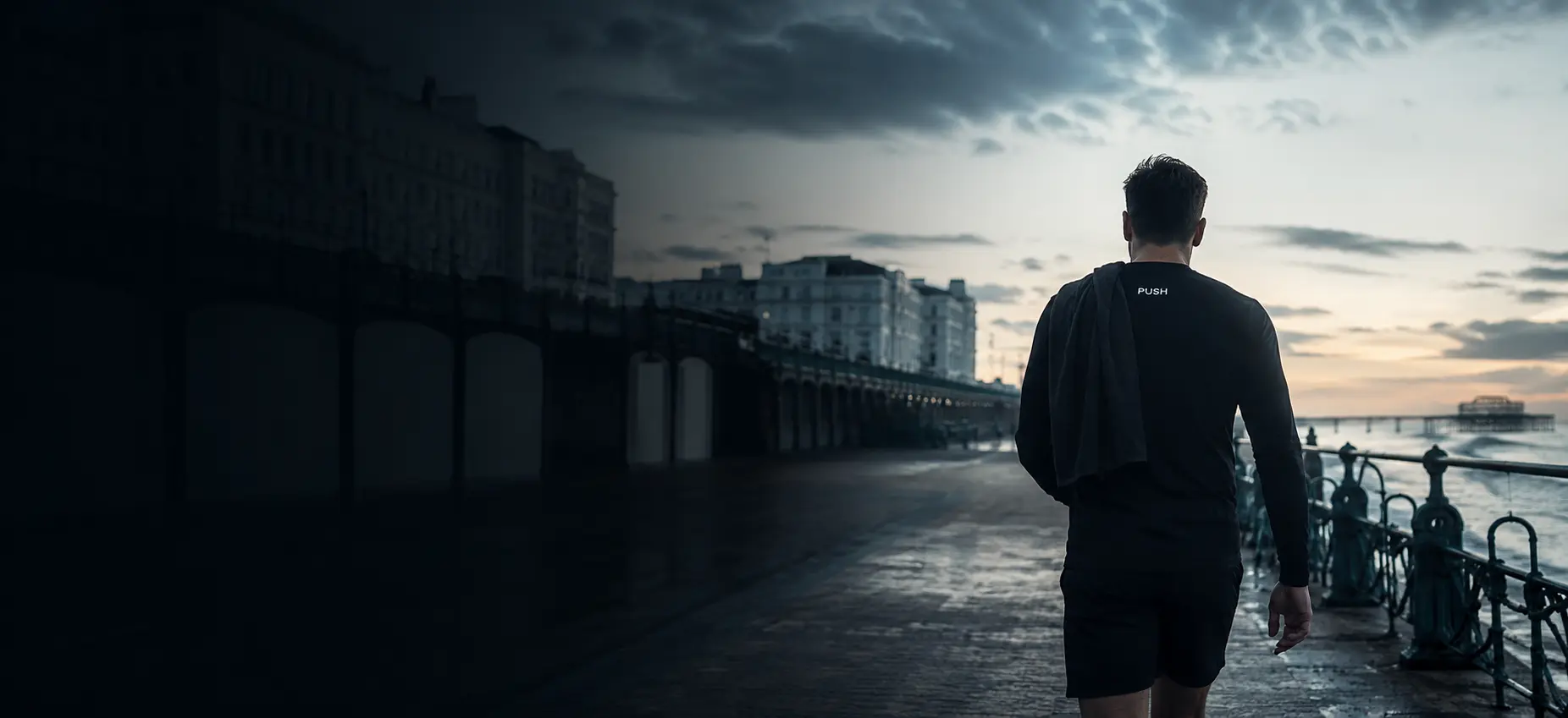 Athlete in PUSH clothing walking along Brighton seafront after training