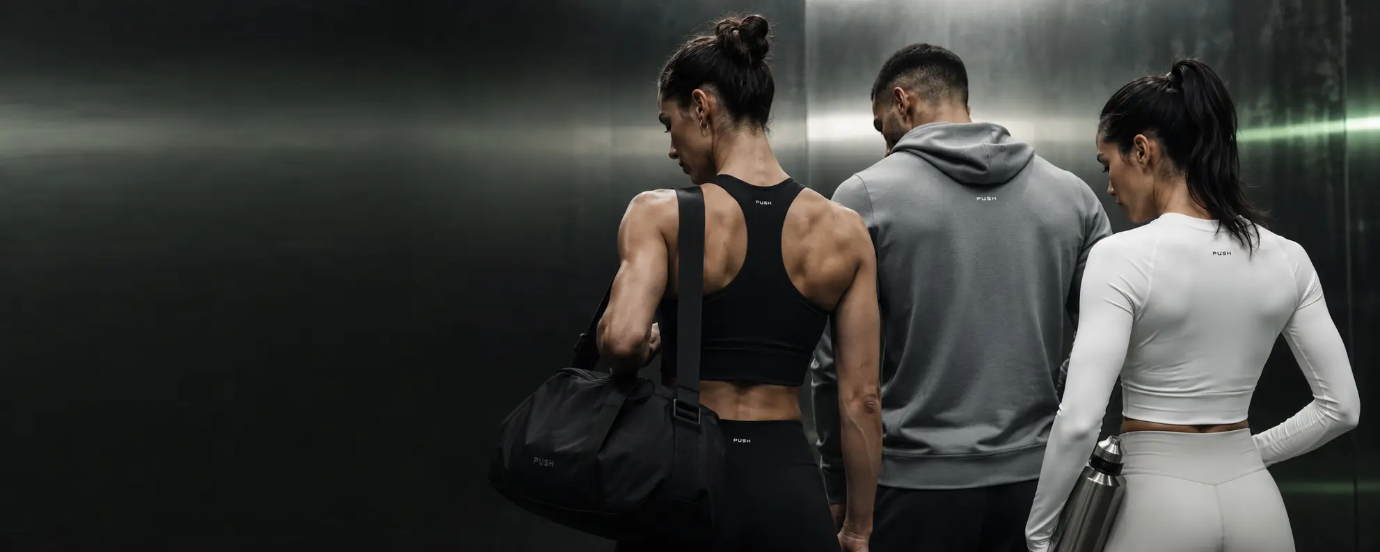 Two women and one man wearing PUSH training clothing